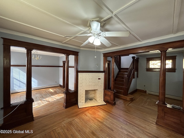 unfurnished living room with a baseboard heating unit, stairs, wood finished floors, and ornate columns