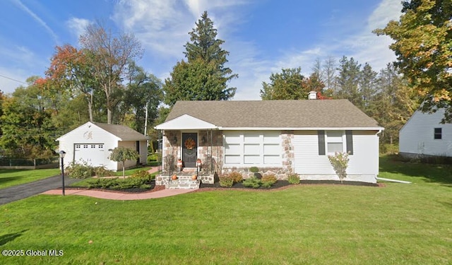 single story home with a shingled roof, a detached garage, a front yard, an outdoor structure, and driveway