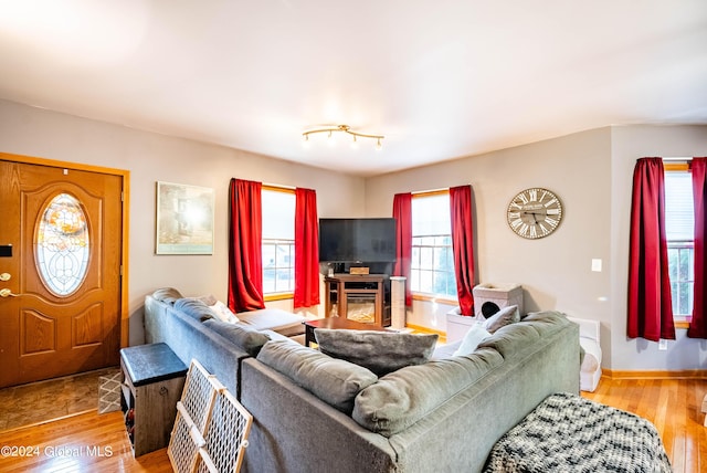 living room featuring wood finished floors and baseboards