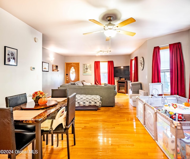 dining area featuring light wood-style flooring and a ceiling fan