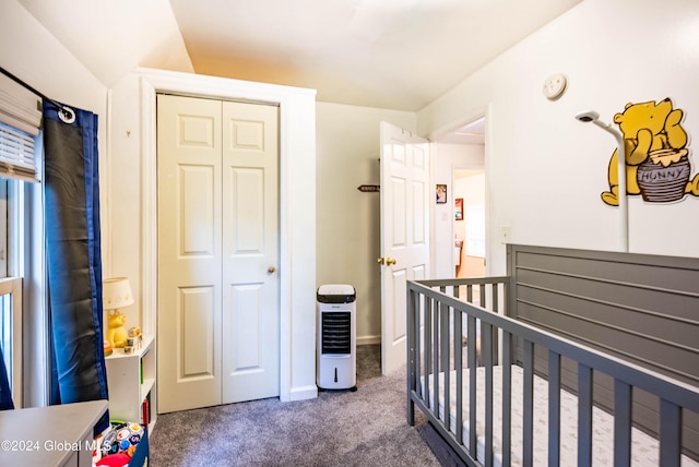 carpeted bedroom featuring a crib, baseboards, and a closet