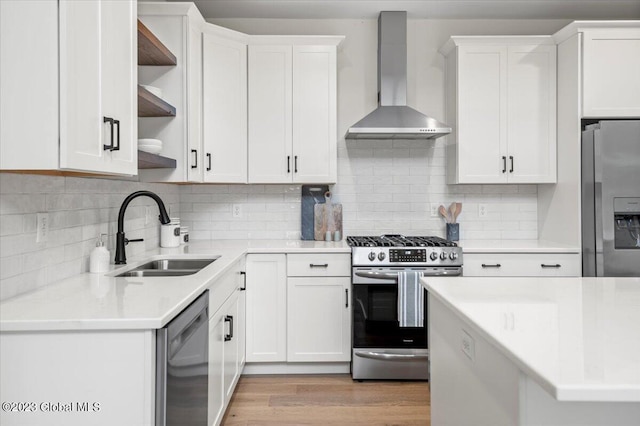 kitchen with a sink, light countertops, stainless steel appliances, wall chimney exhaust hood, and open shelves