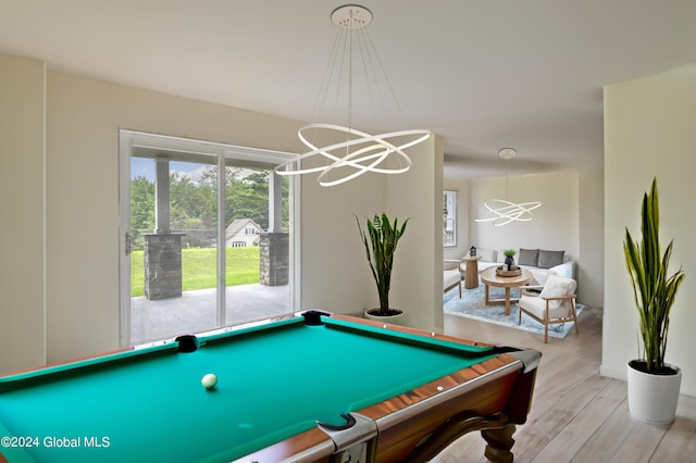 game room with wood finished floors and pool table