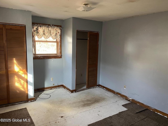 unfurnished bedroom with a closet and baseboards