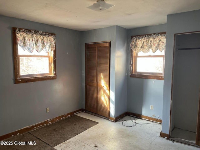 unfurnished bedroom with a closet and baseboards