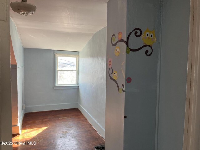 interior space featuring visible vents, baseboards, and wood finished floors