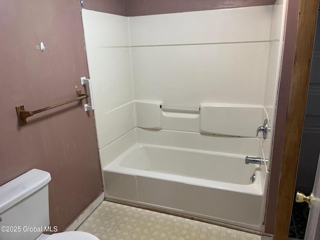 bathroom with tub / shower combination, toilet, and tile patterned floors