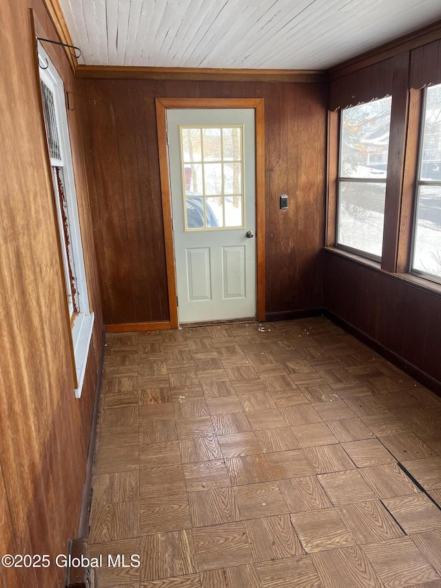 entryway featuring wood walls