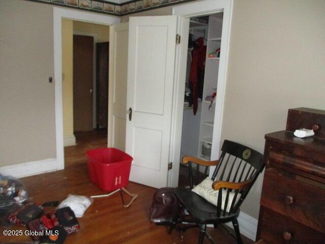 sitting room featuring baseboards and wood finished floors