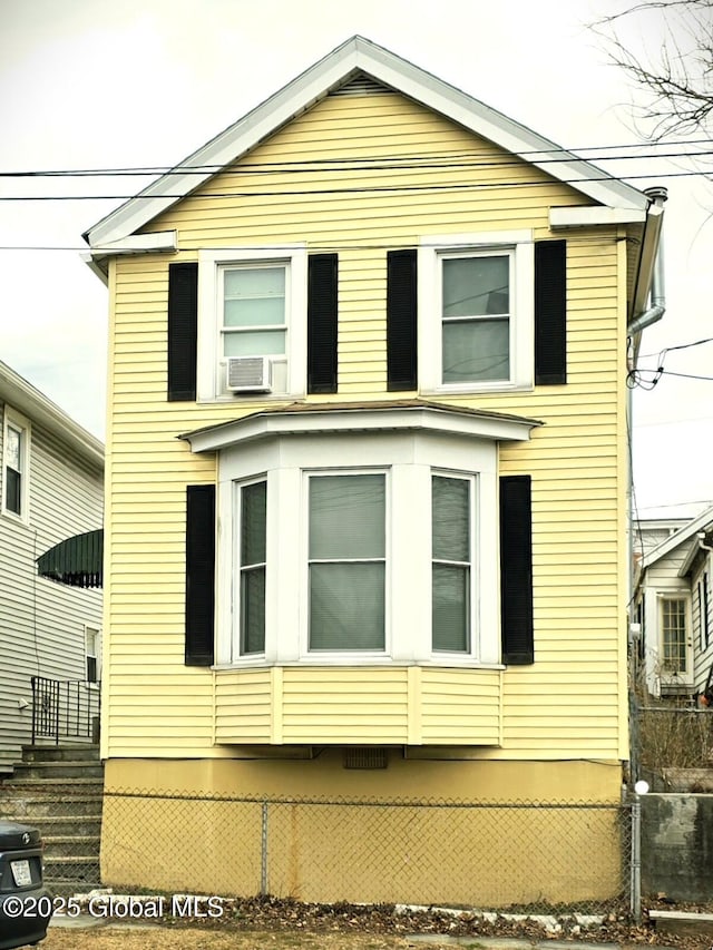 view of side of property with cooling unit and fence