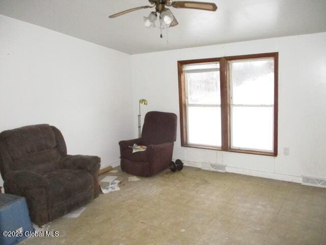 sitting room featuring visible vents and a ceiling fan