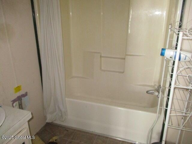 bathroom featuring vanity, tile patterned floors, and shower / tub combo