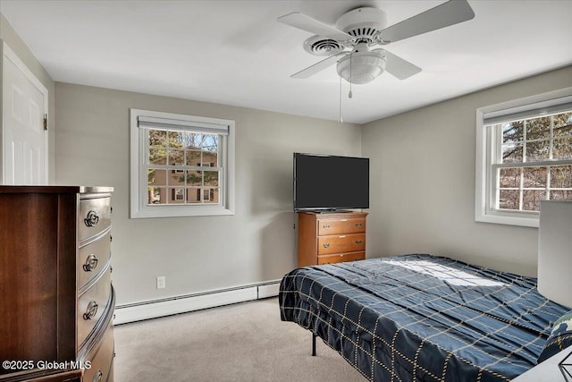 bedroom with a baseboard heating unit, a ceiling fan, and carpet flooring