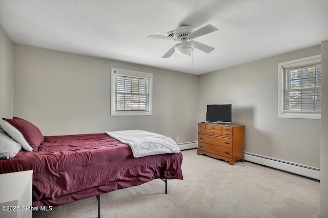 bedroom with a ceiling fan, light colored carpet, and a baseboard radiator