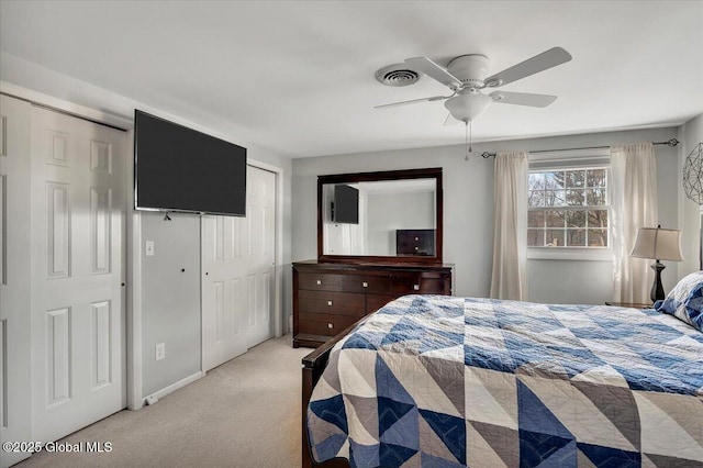 bedroom featuring light colored carpet and ceiling fan