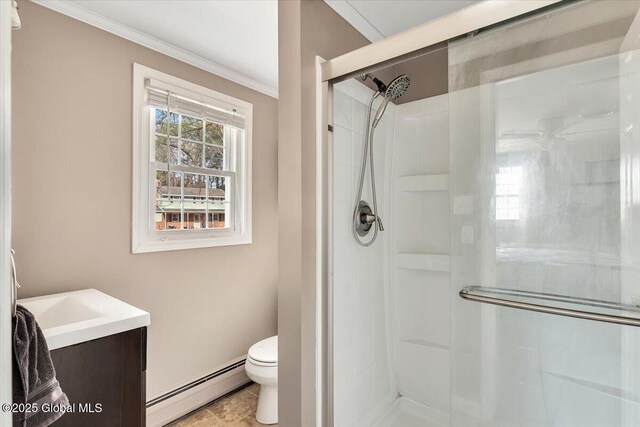 bathroom featuring vanity, a stall shower, crown molding, toilet, and baseboard heating