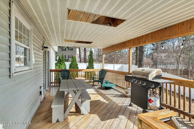 wooden terrace with grilling area and fence