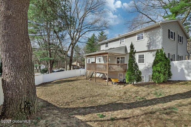 back of house featuring a fenced backyard, a deck, and stairway