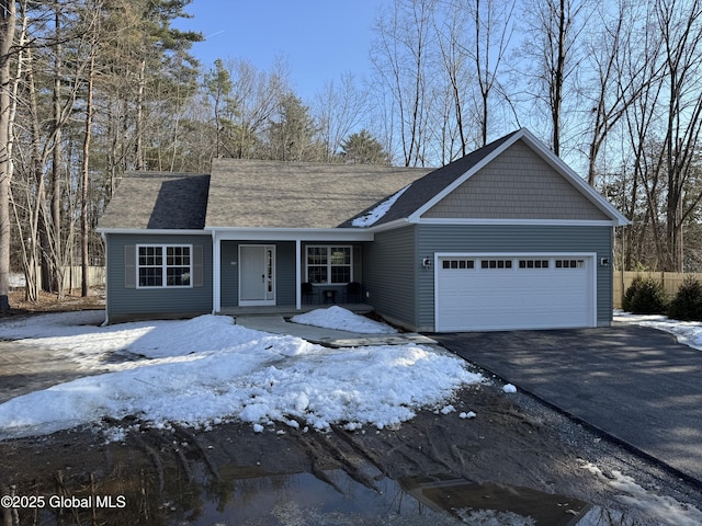 view of front of house with aphalt driveway and an attached garage