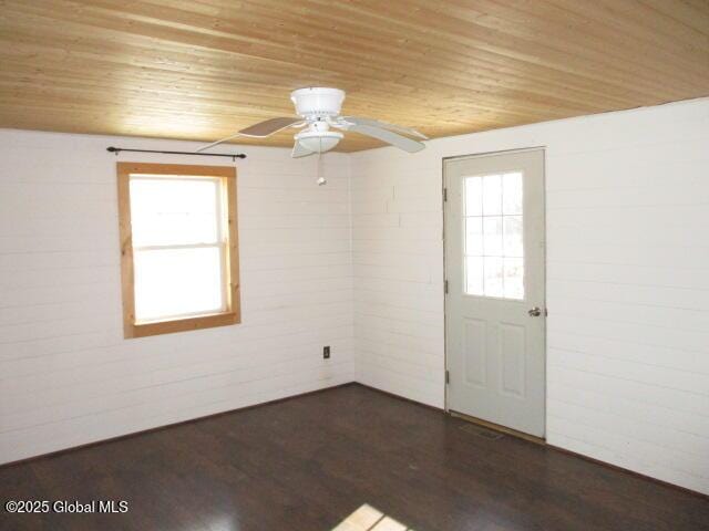 unfurnished room featuring ceiling fan, wood ceiling, and dark wood-style floors