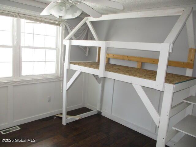 storage area featuring visible vents and a ceiling fan