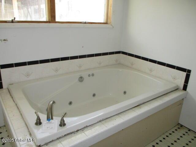 bathroom featuring a tub with jets