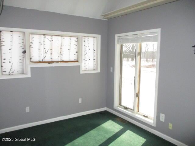 unfurnished room with baseboards