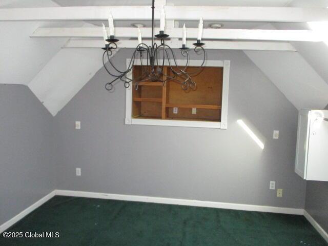 additional living space featuring carpet flooring, baseboards, and lofted ceiling