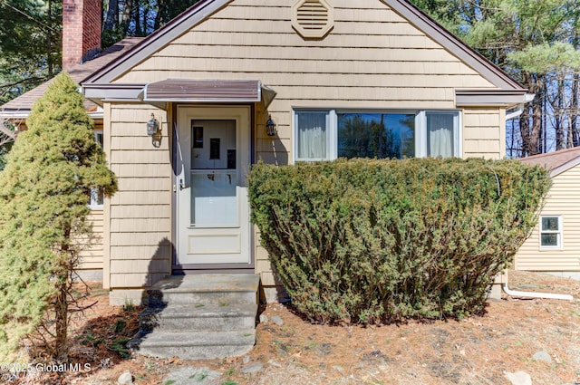 view of front of home featuring a chimney