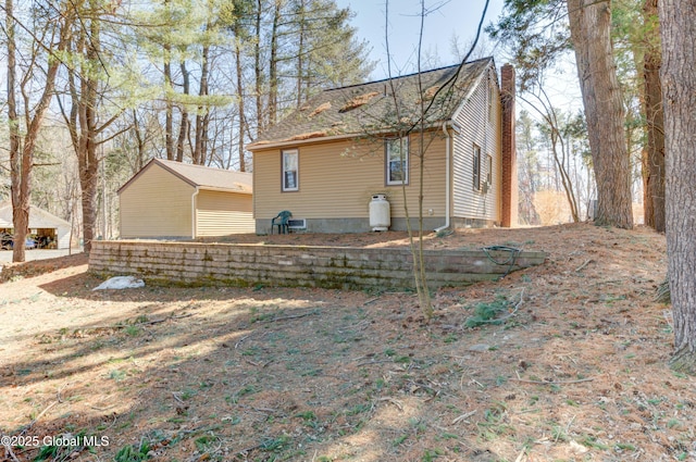 back of house with a chimney