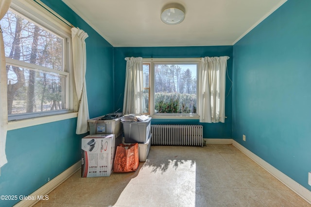 miscellaneous room with tile patterned floors, baseboards, radiator heating unit, and crown molding