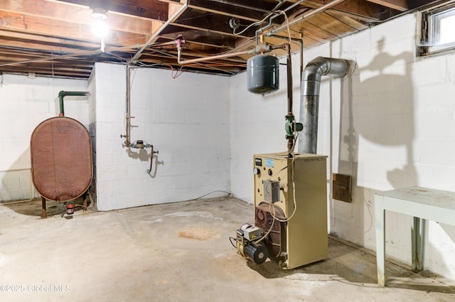 unfinished basement featuring a heating unit and heating fuel