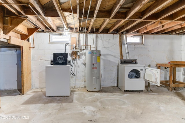 basement with water heater and separate washer and dryer