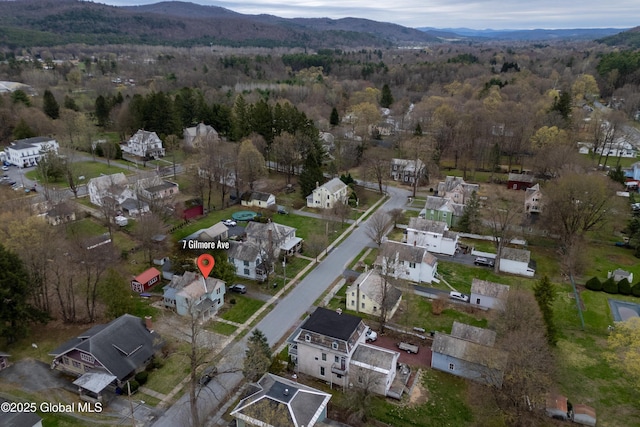 aerial view with a residential view, a wooded view, and a mountain view