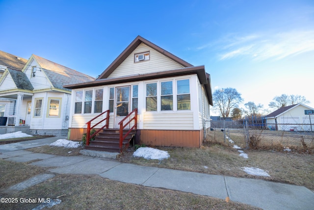 bungalow-style house featuring fence