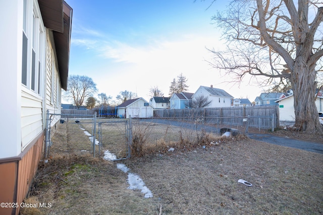 view of yard featuring fence and a residential view