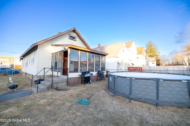 back of house featuring a fenced in pool and fence