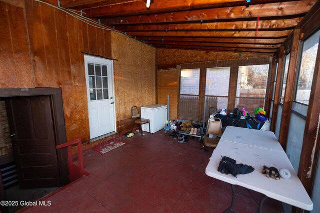 unfurnished sunroom with vaulted ceiling