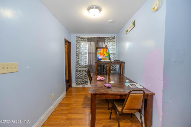 dining area featuring baseboards and wood finished floors