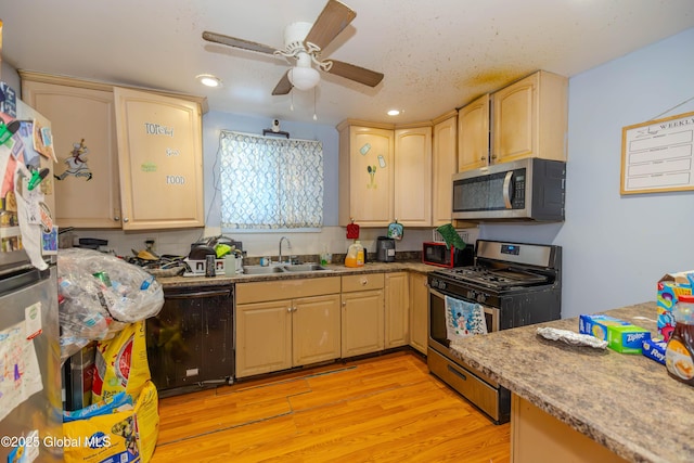 kitchen featuring a ceiling fan, recessed lighting, a sink, stainless steel appliances, and light wood-type flooring