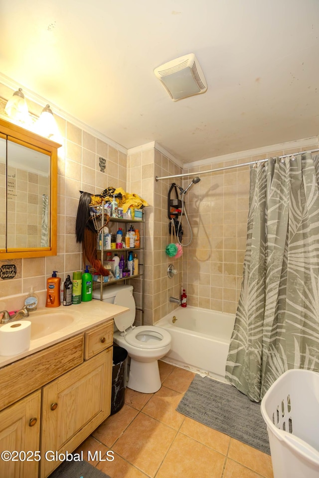 full bath featuring toilet, tasteful backsplash, tile walls, tile patterned flooring, and vanity