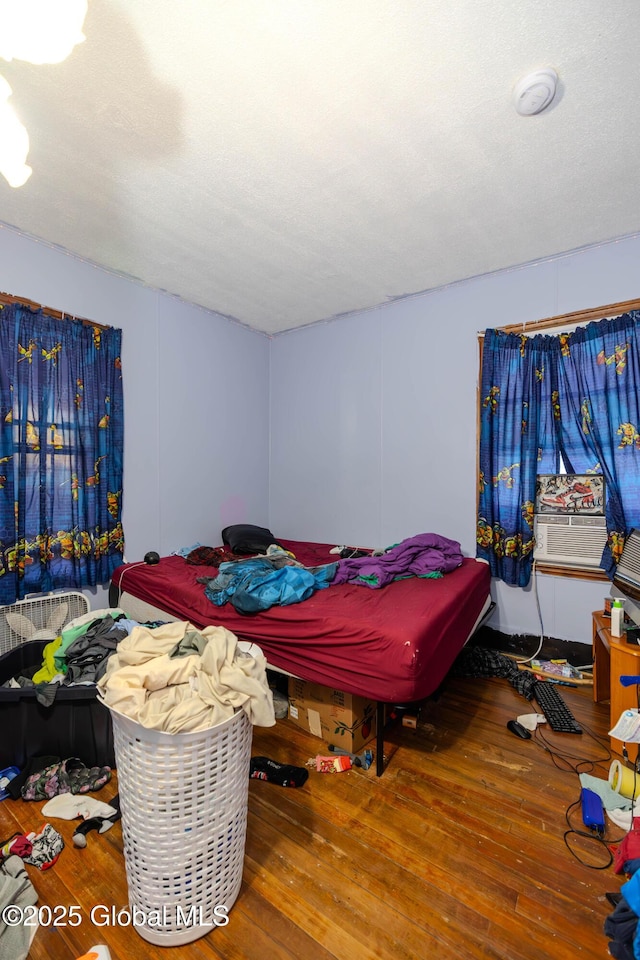 bedroom with hardwood / wood-style flooring