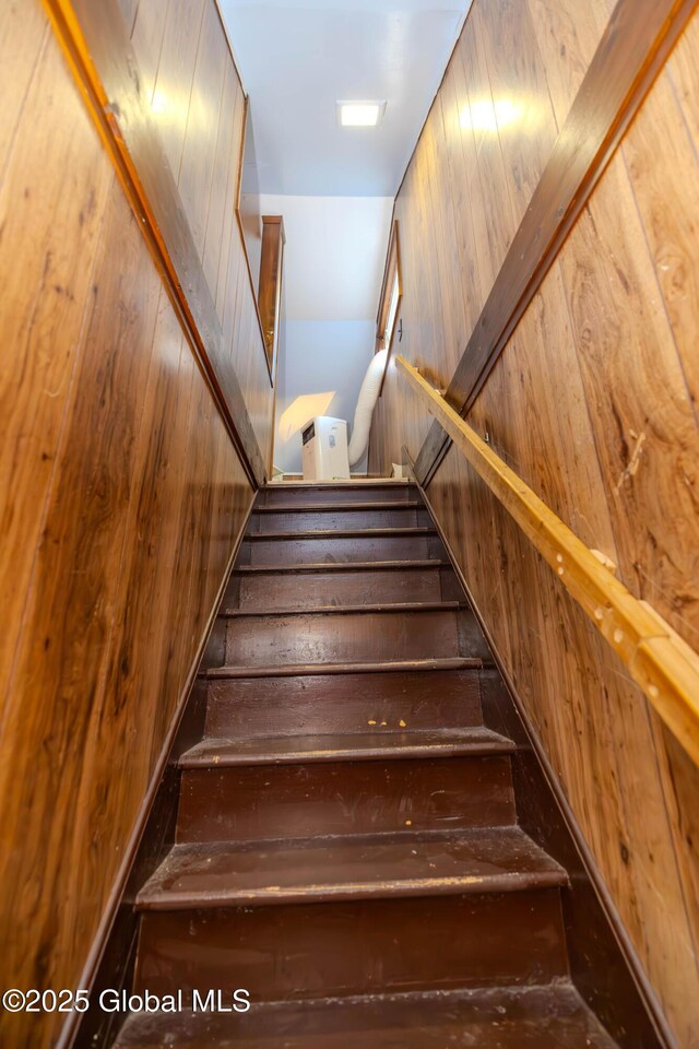 stairs featuring wooden walls