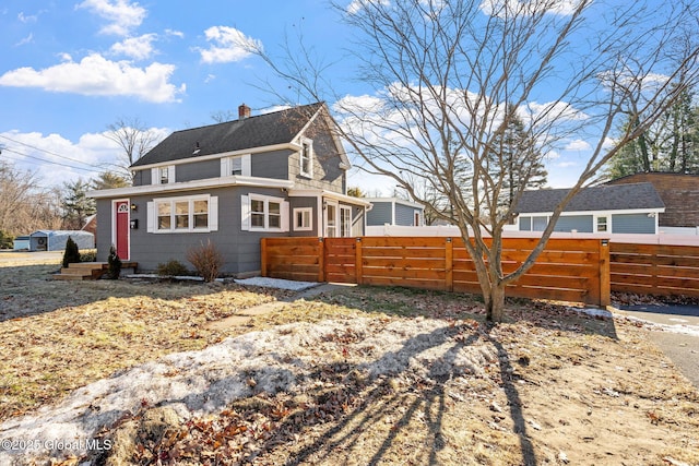 view of property exterior featuring fence and a chimney