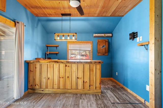 bar featuring baseboards, wood finished floors, and wooden ceiling