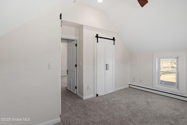 bonus room with baseboards, a barn door, carpet floors, vaulted ceiling, and a baseboard radiator