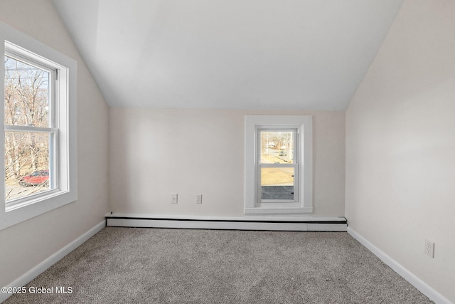 empty room with lofted ceiling, carpet flooring, baseboards, and a baseboard radiator