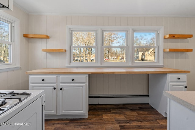 kitchen featuring a baseboard heating unit, open shelves, built in desk, and butcher block counters