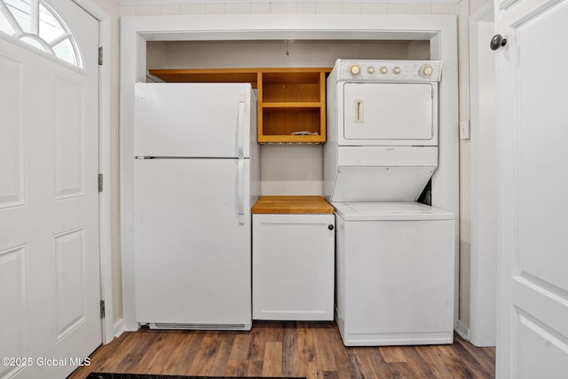 laundry area featuring dark wood finished floors and stacked washer and clothes dryer