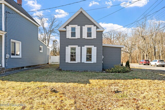 view of property exterior featuring a yard and fence